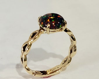 14kt yellow gold infinity ring with 8mm rd black opal