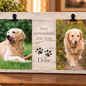 May include: A rectangular light wood frame with a weathered finish featuring two black metal clips for holding photos. The center panel displays the text Your personalized text here, two black paw print icons, and the name Duke in black font.