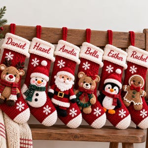 May include: Six red and white crocheted Christmas stockings featuring white cuffs embroidered with the names Daniel, Hazel, Amelia, Bella, Esther, and Rachel. Each stocking displays a unique 3D crocheted character: a reindeer, snowman, Santa, bear, penguin, and gingerbread person.