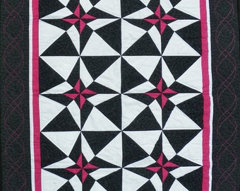 Black, white, and fuchsia geometric quilt for wall hanging, small lap or even modern baby quilt.