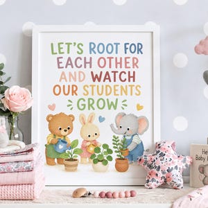 May include: A white framed wall art print featuring the text LET'S ROOT FOR EACH OTHER AND WATCH OUR STUDENTS GROW in colourful letters. Below the text are illustrations of a brown bear, a rabbit, and an elephant watering small potted plants.