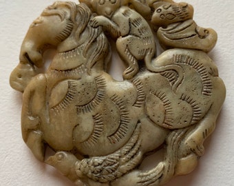 Jade pendant representing a monkey riding a horse