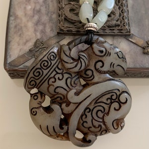 Jade pendant representing the head of a ram