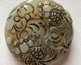Vintage Chinese jade carving representing a pond with water lilies and fishes. The pendant is round (diameter is 2 inches) and heavy