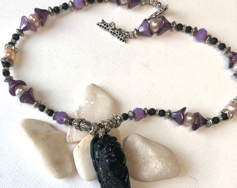 Black obsidian cicada on purple and white necklace