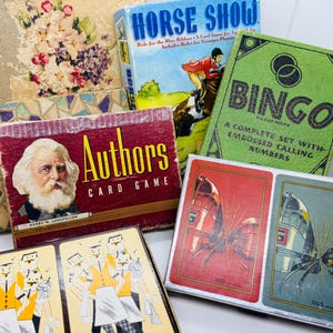 May include: A collection of vintage board games including Bingo, Authors, and Horse Show. The games are in various colors and feature illustrations of people, animals, and numbers.