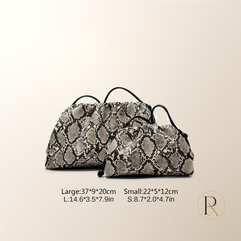 May include: Two gathered pouches with a snakeskin pattern in shades of gray, black, and white. The large pouch measures 14.6 by 3.5 by 7.9 inches, and the small pouch measures 8.7 by 2.0 by 4.7 inches. Both feature black handles and drawstring closures.
