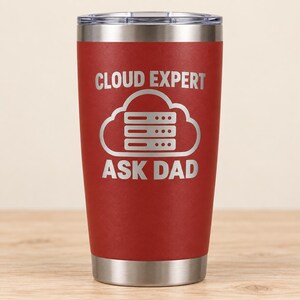 May include: A red stainless steel tumbler with a clear lid. The front features a white engraved graphic of a cloud containing three horizontal server racks. The text CLOUD EXPERT is printed above the cloud, and ASK DAD is printed below the cloud.