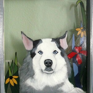 May include: A painting of a white and gray dog with blue eyes, set against a green background with yellow and red flowers.