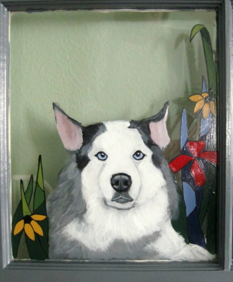 May include: A painting of a white and gray dog with blue eyes, set against a green background with yellow and red flowers.