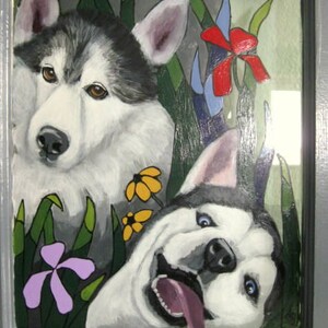 May include: A painting of two dogs, one with black and white fur and the other with gray and white fur. The dogs are painted in a cartoon style with large eyes and expressive faces. The background is a green and blue landscape with flowers.