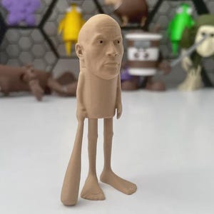 May include: A light tan 3D printed figurine featuring a realistic human head atop a cylindrical body with thin legs and feet. The figure holds a long, smooth, club-like object in its right hand. The entire structure is monochromatic and matte.