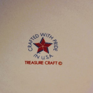 May include: A white ceramic plate with a red, white and blue star and the text "Crafted with Pride in U.S.A. Treasure Craft &copy;".
