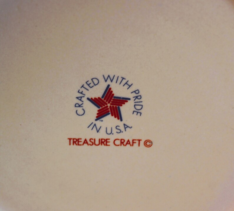 May include: A white ceramic plate with a red, white and blue star and the text "Crafted with Pride in U.S.A. Treasure Craft &copy;".