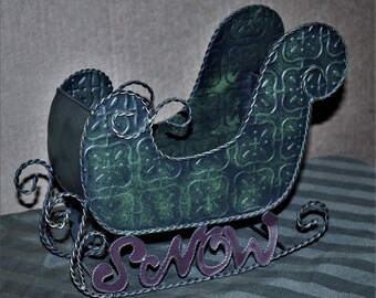 Metal Sleigh with the word Snow on the Rails