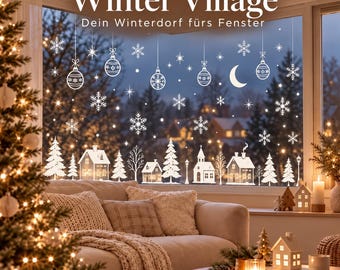 May include: White window decals featuring a winter village scene with houses, pine trees, snowflakes, hanging ornaments, and a crescent moon. The text reads Winter Village and The Williams Edit. The decals are applied to a large glass window.