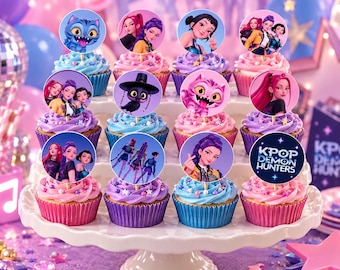 May include: A set of twelve cupcakes arranged on a white tiered stand, each topped with a circular paper topper featuring K-Pop Demon Hunters characters, creatures, and the text KPOP DEMON HUNTERS, with pink and blue frosting and sprinkles.