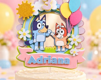May include: A layered cake topper featuring the cartoon characters Bluey and Bingo, a glittery yellow sun, three colorful balloons, and a large number 3. A pink banner at the bottom displays the name Adriana in blue letters.