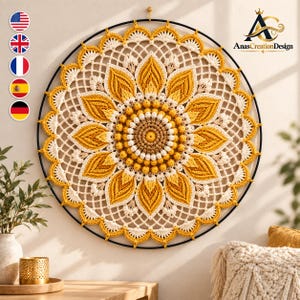 May include: A circular wall hanging featuring a complex crochet sunflower design in shades of yellow, cream, and tan. The piece is mounted on a thin black metal hoop, showcasing intricate petal patterns and a textured center.