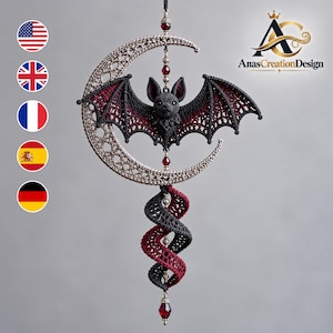 May include: A hanging ornament featuring a crocheted black bat with red wing accents centered within a metallic silver crescent moon. A spiral tail in black and red crochet hangs below, accented with small red beads and silver findings.