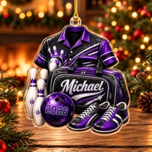 May include: A decorative acrylic ornament featuring a purple and black bowling shirt, a bowling bag with the name Michael, a purple bowling ball with the number 2026, and a pair of bowling shoes, all accented with white bowling pins.