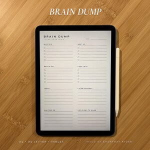 May include: A digital tablet displaying a Brain Dump planner template with sections for Must Do, Next Up, Reach Out, Look Into, Ideas, Later/Someday, Waiting On, and Decisions to Make, accompanied by a white stylus pen on a light wood grain surface.