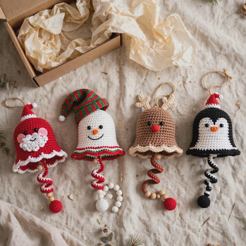 Close-up of handmade crochet snowman bell ornament,
white bell with striped winter hat and carrot nose