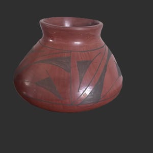 May include: A terracotta-colored ceramic pot with a wide, rounded body and a short, flared neck. The exterior surface features dark brown, angular geometric patterns consisting of triangles and intersecting lines painted across the reddish base.
