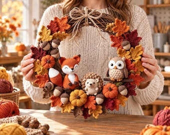 May include: A round grapevine wreath decorated with crocheted autumn leaves in shades of red, orange, and yellow. The wreath features crocheted figures of a fox, a hedgehog, and an owl, along with small crocheted pumpkins and acorns attached throughout.