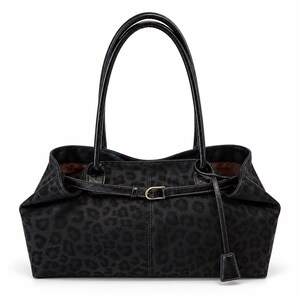 May include: A black handbag featuring a subtle tonal leopard print pattern. The bag has two long shoulder straps, a horizontal strap across the front with a small gold-toned metal buckle, and a dangling rectangular charm attached to the side.