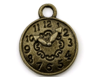 May include: Antique gold-toned metal clock charm with Roman numeral markings and a detailed design. The clock face has a decorative border and a pair of hands pointing to the time.