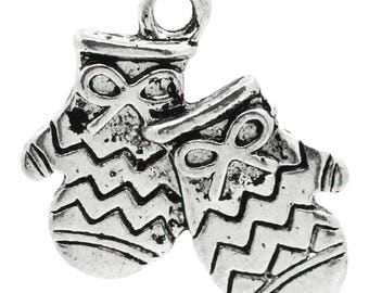 May include: Antique silver charm featuring a pair of mittens with a zig-zag pattern and a bow on each mitten.