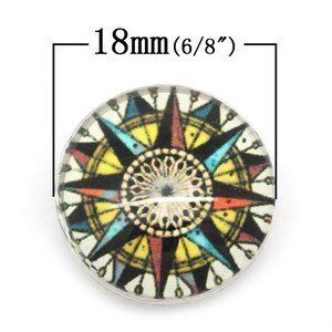 May include: A 18mm (6/8 inch) round glass cabochon with a colorful compass design. The compass features a black background with a yellow, red, blue, and white design.
