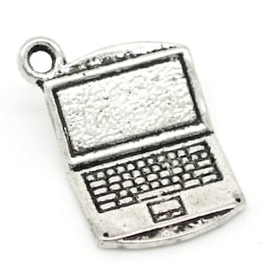 May include: Silver charm in the shape of a laptop computer. The charm has a detailed design with a screen, keyboard, and touchpad.