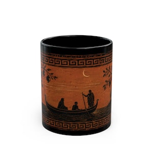 May include: A black ceramic mug featuring a terracotta-colored band around the center. The band displays a black silhouette illustration of three figures in a boat on water, with a crescent moon above and a Greek key pattern bordering the top and bottom.