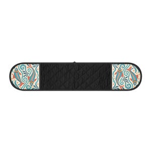 May include: A double oven glove featuring a solid black quilted centre section and two end panels decorated with a repeating pattern of stylised fish in shades of blue, orange, and cream, all outlined with a dark black fabric trim.