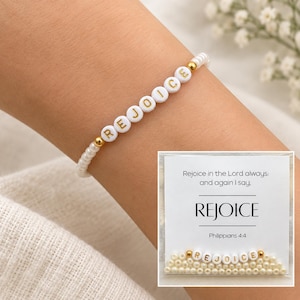 May include: A beaded bracelet featuring white round beads and gold-toned spacers, with white letter beads spelling REJOICE. The accompanying card displays the text: Rejoice in the Lord always: and again I say, REJOICE Philippians 4:4.