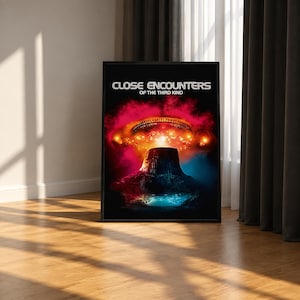 May include: A framed rectangular poster featuring the movie title Close Encounters of the Third Kind in white text. The artwork displays a dark mountain silhouette against a vibrant background of glowing red clouds and a bright blue light source.