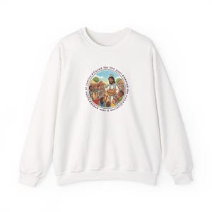 May include: A white crewneck sweatshirt featuring a circular graphic on the chest. The illustration depicts a figure with a halo offering bread to a diverse group of people. The text surrounding the image reads: Spoke of justice, Cared for the poor, Healed the sick, Jesus was a socialist.