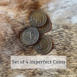 May include: Four antique-style bronze coins with a detailed design, arranged on a textured, brown and tan surface. The coins have a circular shape with a raised border and a central image. The text "Set of 4 imperfect Coins" is displayed in a white box.