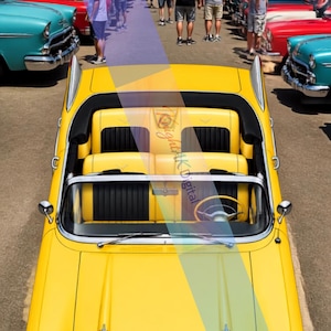 May include: A bright yellow convertible car with chrome accents and a black and yellow interior, featuring a prominent hood, dual headlights, and tail fins. The vehicle is parked at an outdoor event with a sign reading Classic CAR SHOW.