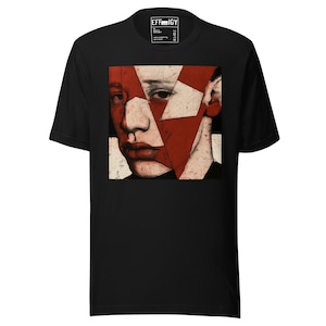 May include: A black short-sleeve t-shirt featuring a square graphic print on the chest. The print displays a stylized, fragmented portrait of a face in shades of red, white, and black, with the text EFFIGY printed on the inner neck label.