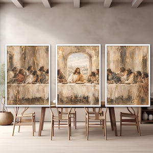 May include: A triptych of framed wall art prints depicting the Last Supper in a muted, textured palette of beige, gold, and brown. The central panel features a central figure at a table, flanked by two side panels showing groups of people.