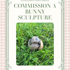 May include: A small, rounded ceramic bunny sculpture with a matte tan finish and dark brown glazed ears. The text above the sculpture reads ALYSSASPOTTERYGARDEN COMMISSION A BUNNY SCULPTURE. The sculpture is positioned within a green grassy area.