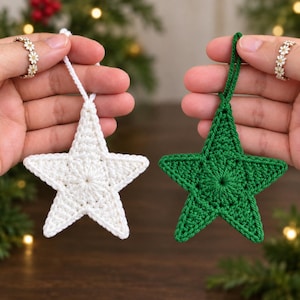 May include: Two five-pointed star ornaments made of crocheted yarn, one in solid white and one in solid green. Each star features a central circular pattern with radiating stitches and a small loop at the top for hanging, showcasing a textured finish.