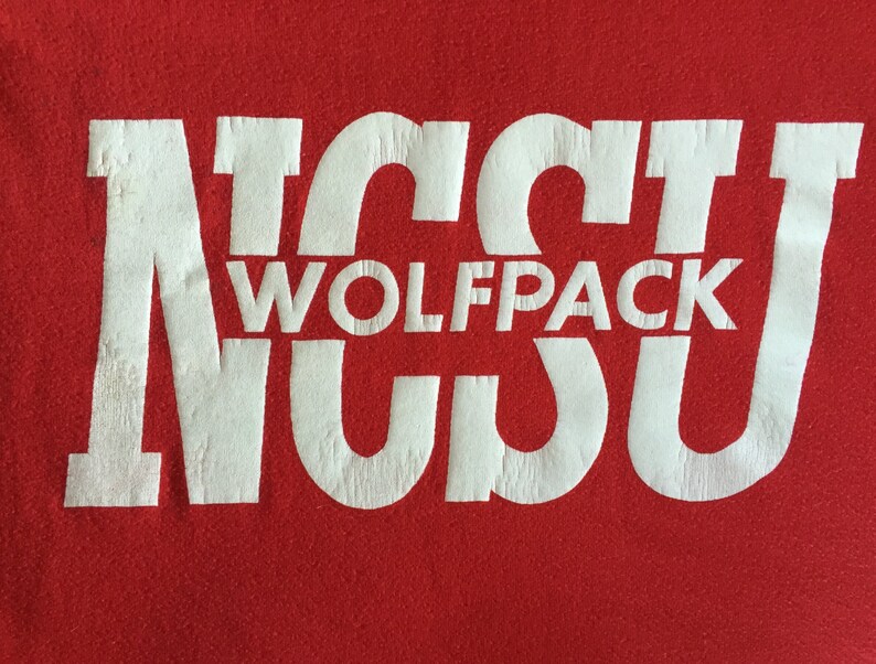 May include: White text on a red background reads "NC State Wolfpack".