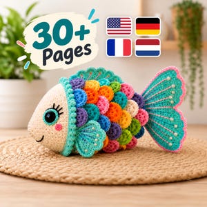 May include: A crocheted fish toy featuring a cream-colored head with black eyes and pink cheeks, followed by a body covered in multi-colored scales in shades of orange, pink, purple, blue, and yellow. The fins and tail are teal with pink edges and small white beads.