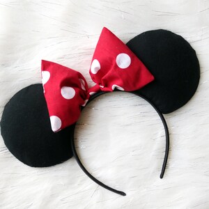 May include: Red and white polka dot bow headband with black mouse ears.