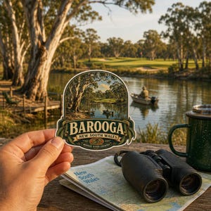 May include: A die-cut sticker featuring a scenic illustration of a river landscape with trees and a small boat, with the text BAROOGA NEW SOUTH WALES MURRAY RIVER COUNTRY printed in a decorative banner at the bottom of the sticker design.