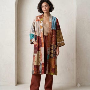 May include: A long-sleeved, open-front duster coat featuring a patchwork design with various colourful fabric panels in shades of red, blue, yellow, and brown. The garment has a straight silhouette, two front pockets, and visible stitching details.